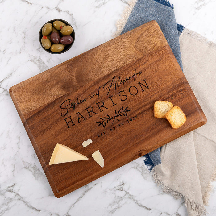 Engraved walnut wood wedding serving board with couple's names and date, perfect personalised gift