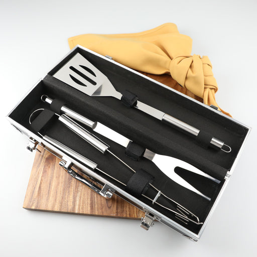 Luxury three-piece BBQ set with spatula, tongs, and fork in engraved aluminium carry case