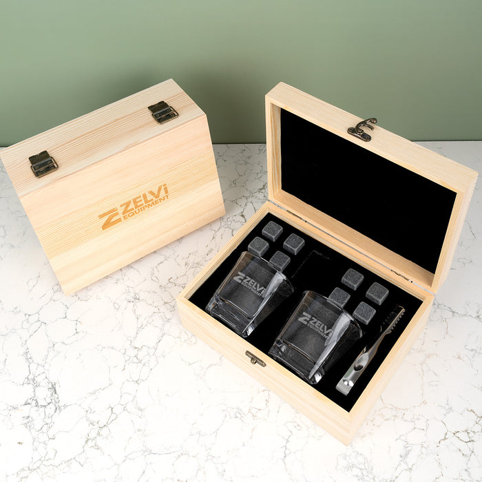 Premium wooden whiskey gift box showcasing personalised glasses, stainless steel tongs and stone pouch, ideal for corporate or executive gifts.