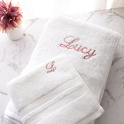 Custom white cotton bath and hand towel set with choice of thread colour and font, ideal for birthdays or newborns