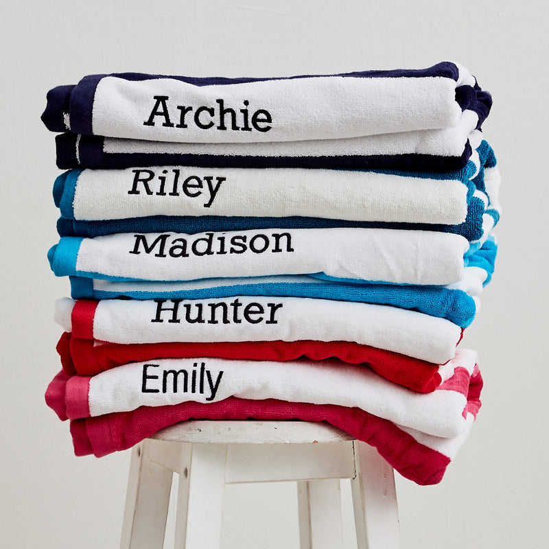 Set of personalised striped towels - each embroidered with a child’s name for a unique Christmas gift
