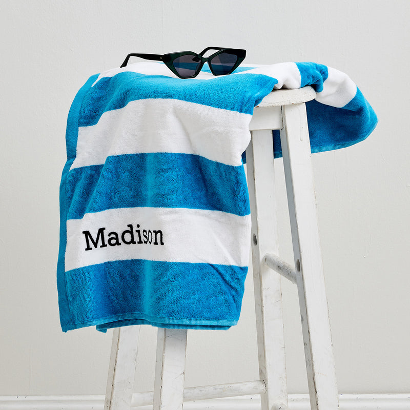 Blue striped cotton towel with child’s name embroidered – great for beach or pool