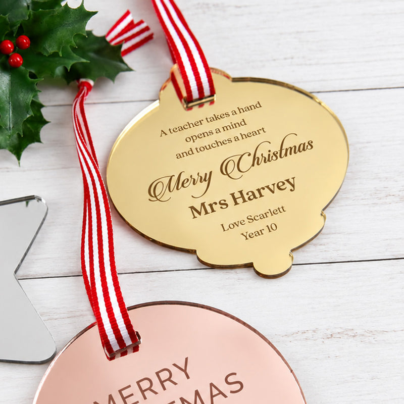 Engraved teacher Christmas ornament in mirror gold acrylic with red and white striped ribbon.