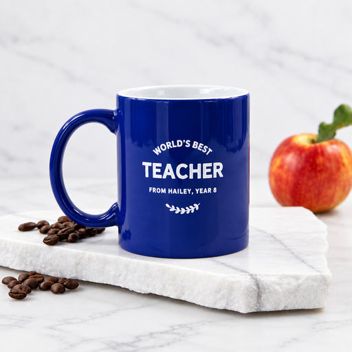 Personalised blue teacher coffee mug engraved with World’s Best Teacher design.