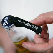 Matte black bottle opener keyring printed with World’s Best Dad slogan