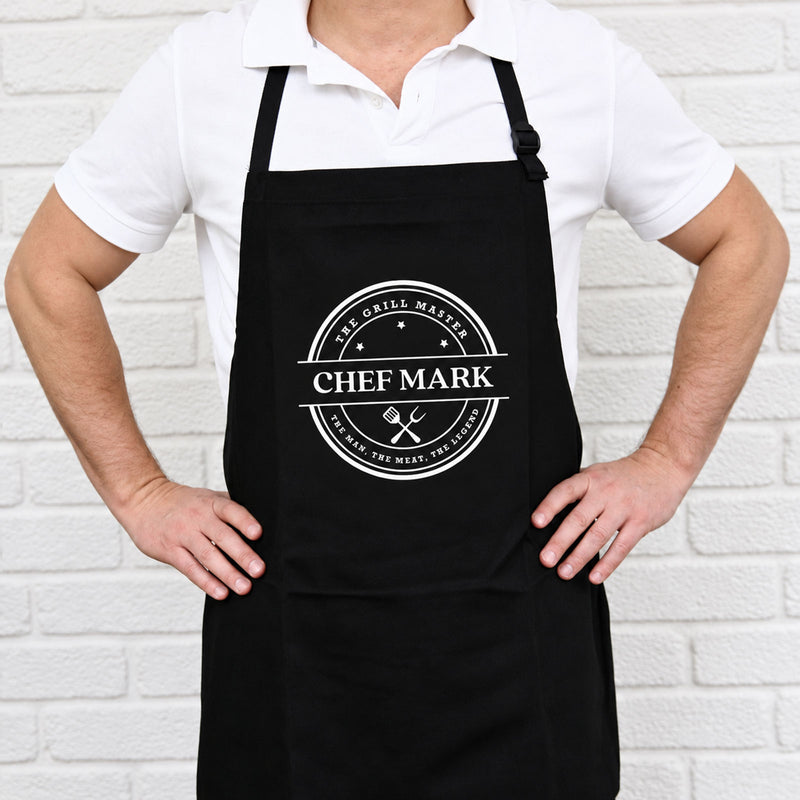 Personalised black BBQ apron with bold white print and custom name, a practical gift for Dad, Grandad or the BBQ King.