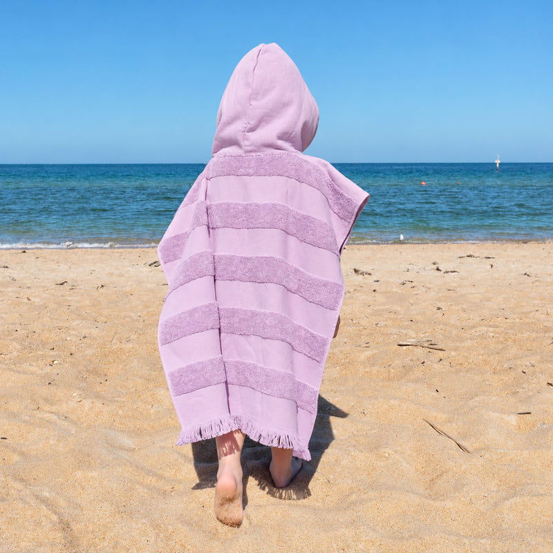 Personalised kids beach towel poncho in lilac with cosy hood and absorbent cotton terry, a practical Christmas gift for children.