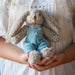 Soft and cuddly 20cm personalised bunny toy featuring removable blue overalls embroidered with a name in your choice of thread colour.