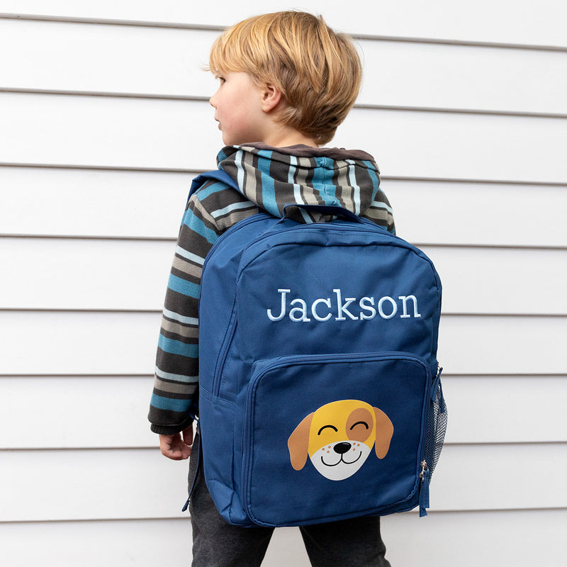 Young child wearing a custom puppy backpack, showing fit and playful design.