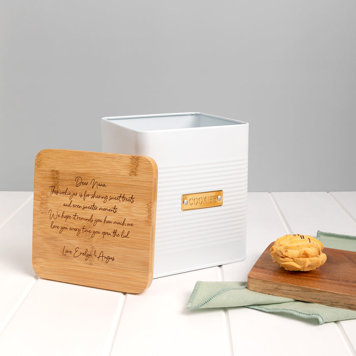Gift-wrapped personalised cookie tin with kraft paper and white satin ribbon, perfect for special occasions.