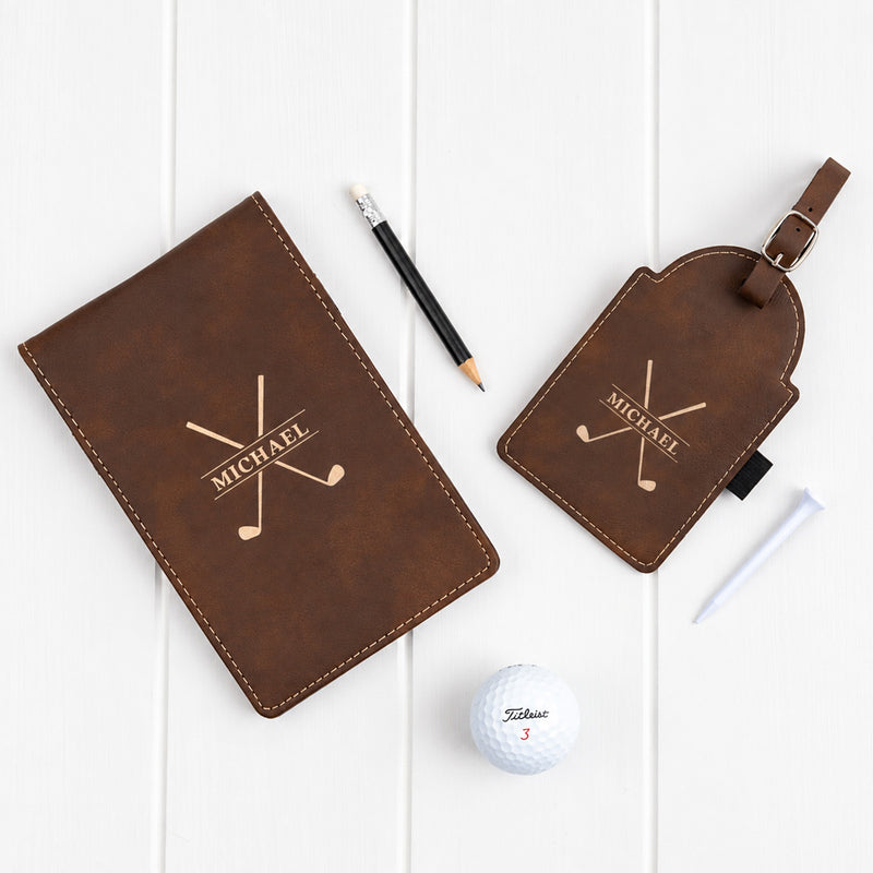 Personalised golf tee tag and score card holder set with metallic gold engraving, three white golf tees and lead pencil.
