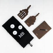 Custom golf gift set featuring a personalised golf towel, scorecard holder, tee tag and printed golf balls with matching initials.