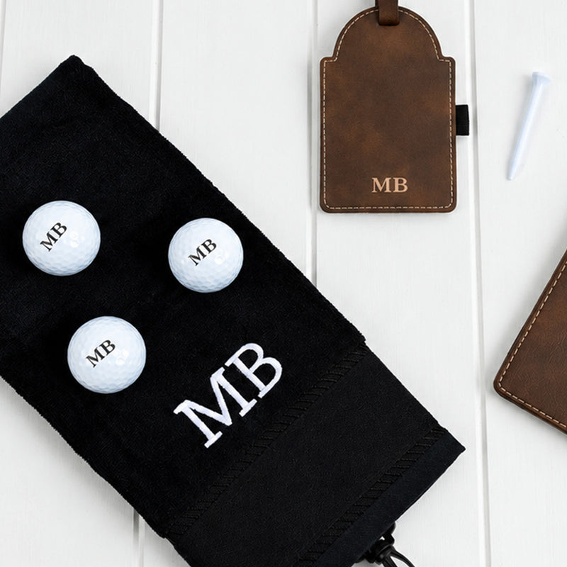 Personalised golf accessory gift set with initialled score card holder, golf tee tag, golf balls and cotton towel