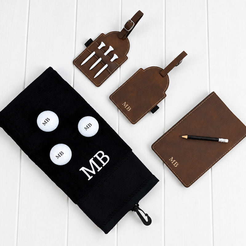 Golf hamper personalised with initials featuring engraved golf accessories, three printed golf balls and embroidered towe
