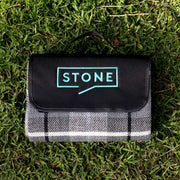 Outdoor picnic setup featuring personalised corporate picnic blanket