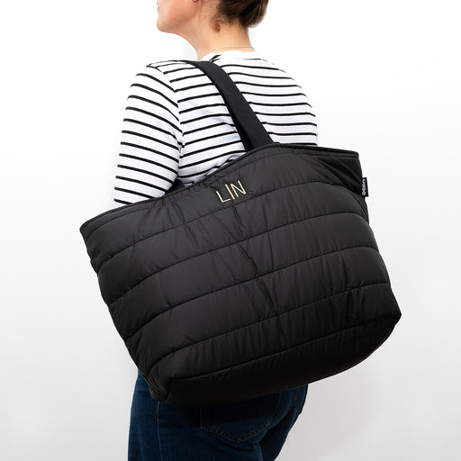 Stylish padded tote with wide cotton straps and secure zip closure