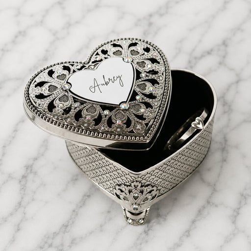 Engraved silver heart jewellery box for storing rings, earrings and small keepsakes, personalised with their name.
