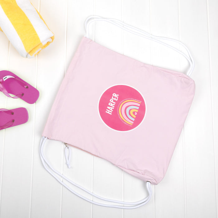 Personalised pink swim bag with towel and flip-flops.
