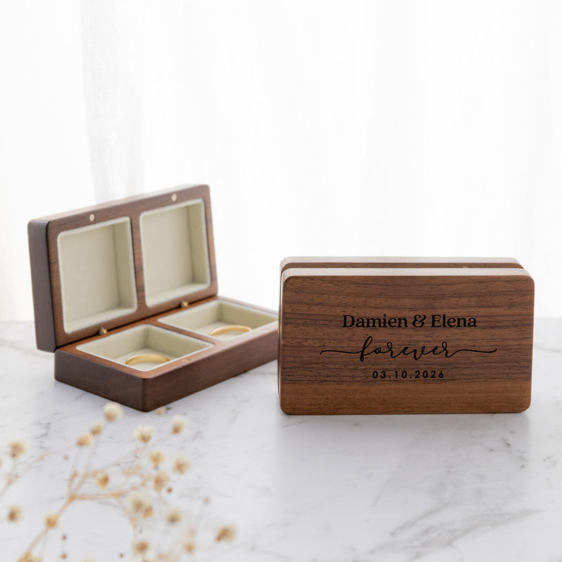 Engraved walnut ring box with velvet-lined wedding ring compartments.
