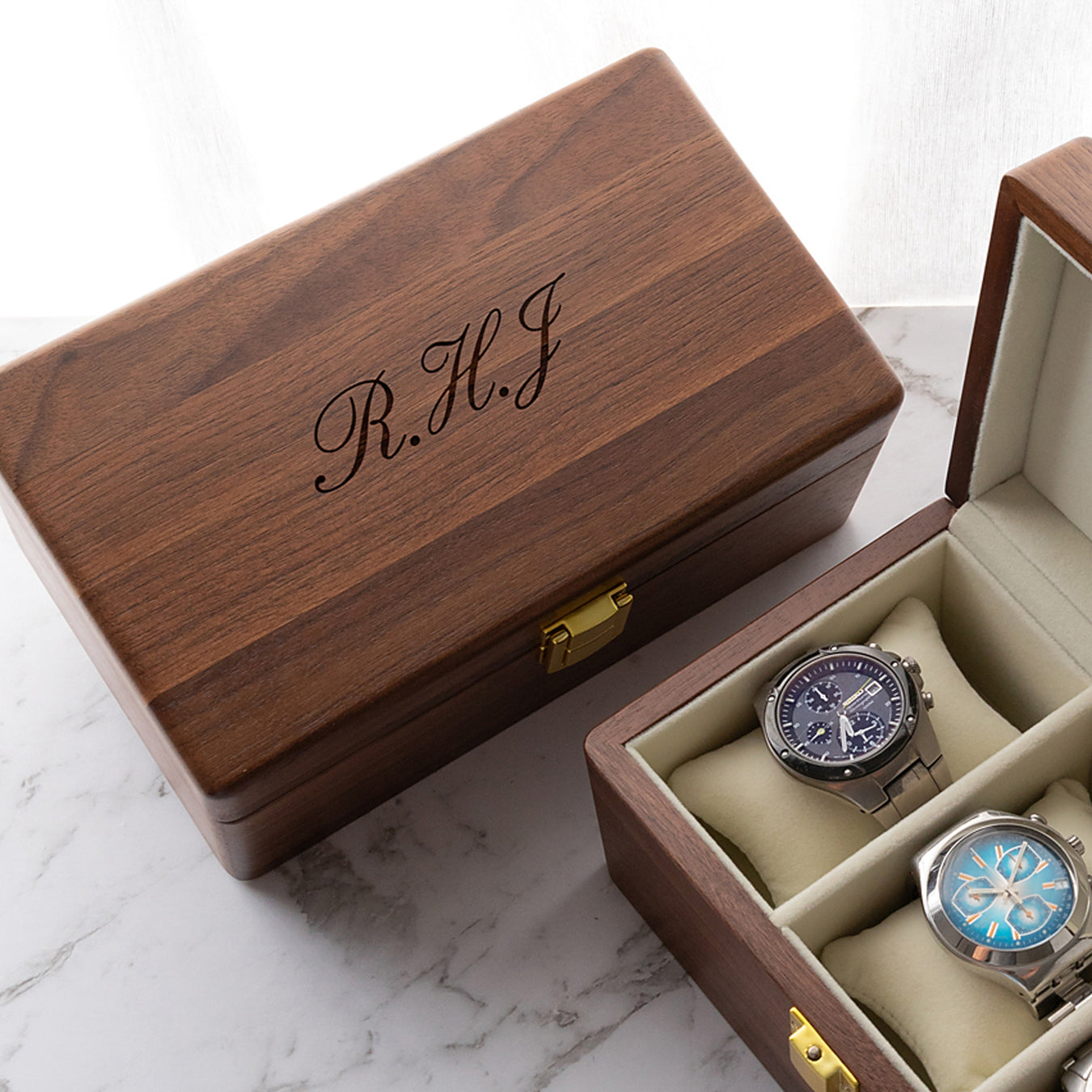 Elegant wooden watch box with hinged lid, soft cushions, and custom engraved design for up to three watches
