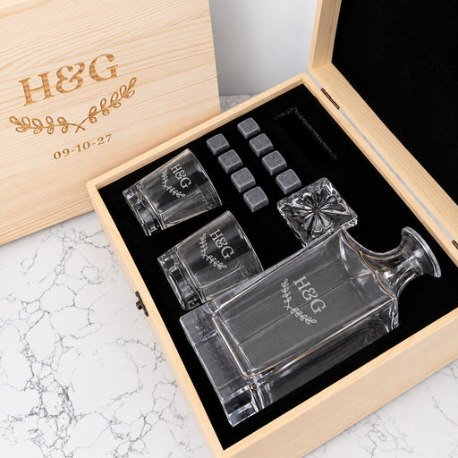 Engraved anniversary decanter set personalised with names and wedding date, complete with matching whiskey glasses and reusable chilling stones.