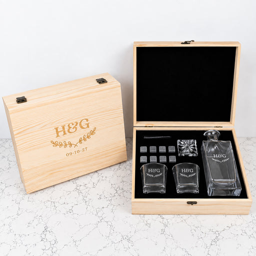 Personalised anniversary whiskey decanter gift set with 870ml decanter, two engraved scotch glasses and whiskey stones in a wooden gift box.