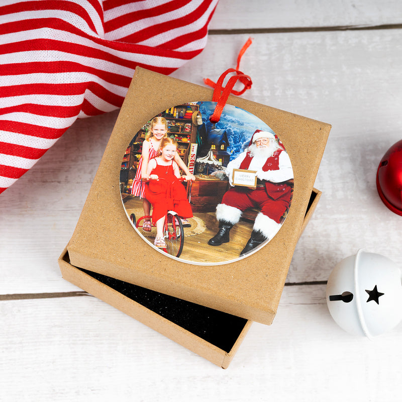 Round photo Christmas ornament with festive red hanging ribbon