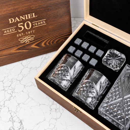 Engraved whiskey decanter gift set with personalised glasses, reusable whiskey stones and custom wooden box for milestone birthdays.