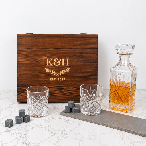 Personalised wooden whiskey gift box with decanter, matching engraved glasses and whiskey stones, a timeless keepsake for newlyweds and couples.