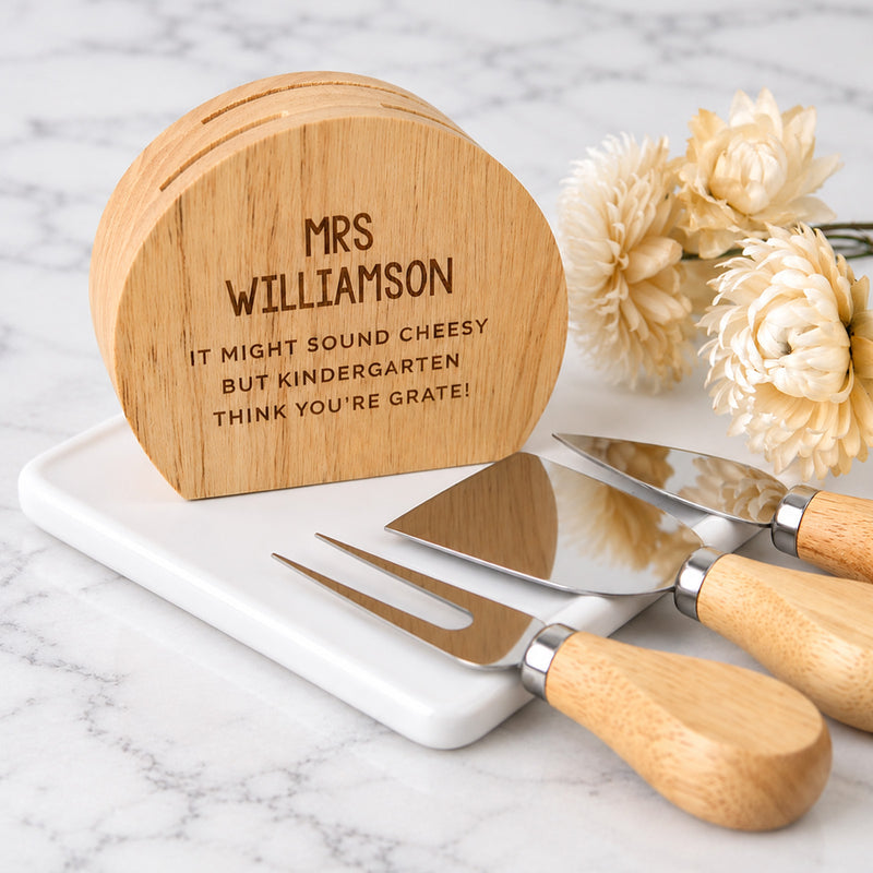 Engraved teacher cheese knife set with three utensils and personalised wooden storage block.