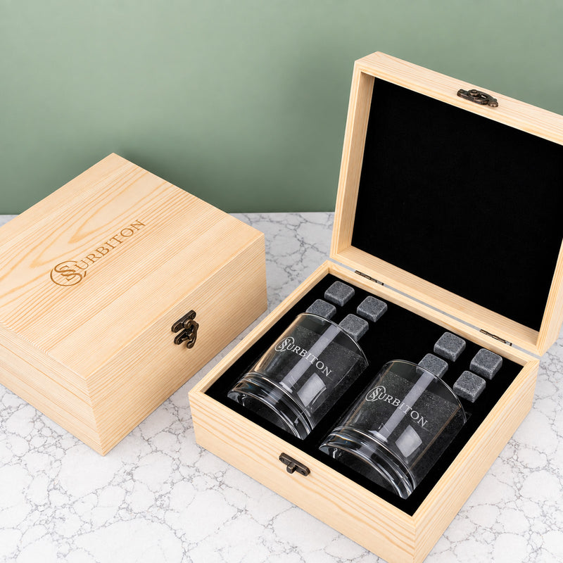 Personalised corporate whiskey gift set with two engraved whiskey glasses, eight reusable whiskey stones and a branded wooden presentation box.