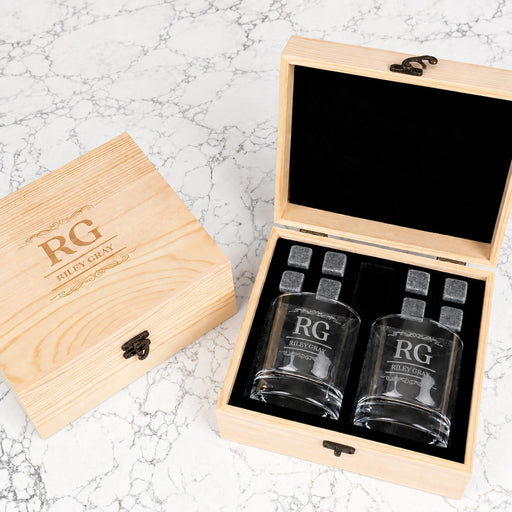 Personalised wooden whiskey gift set with two engraved round glasses and eight reusable whiskey stones, perfect for birthdays and Christmas.