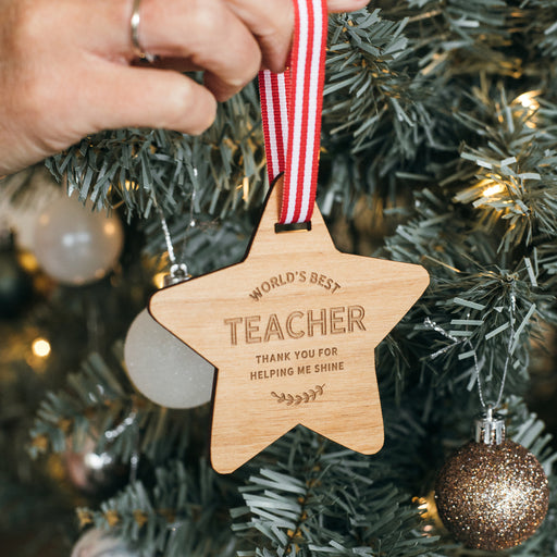 Wooden star Christmas decoration engraved with “World’s Best Teacher”