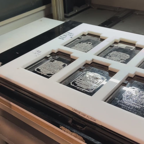 Personalised silver hip flask with custom engraving, presented in a satin-lined gift box.